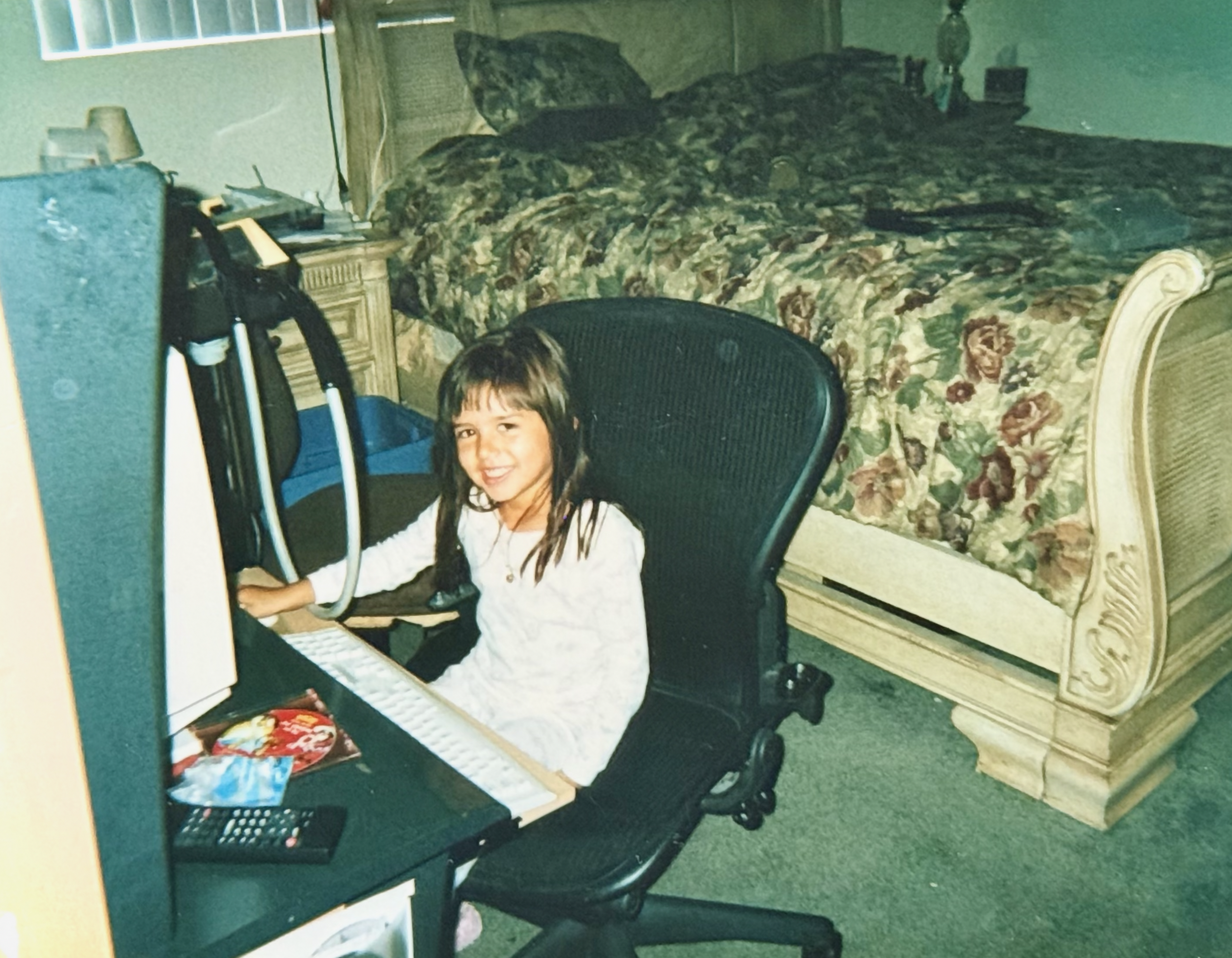 Young Yara as a child at a computer in her bedroom, mid-2000s